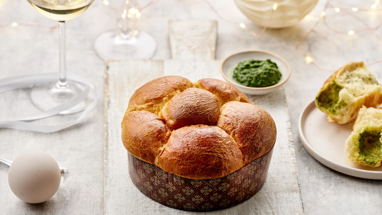 Tear & Share brioche intact in its paper case with a glass of white wine