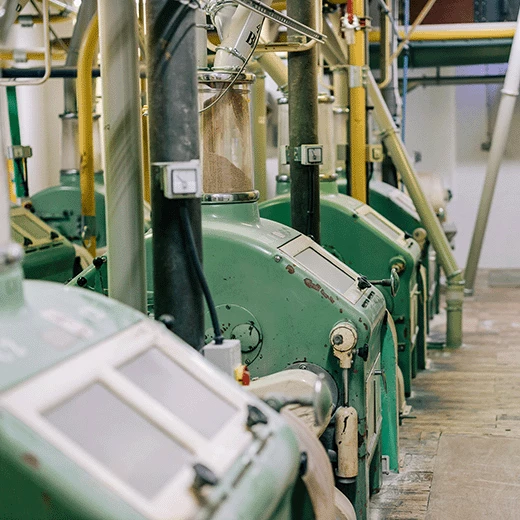 Array of green painted roller-milling machines at Matthews Cotswold Flour.
